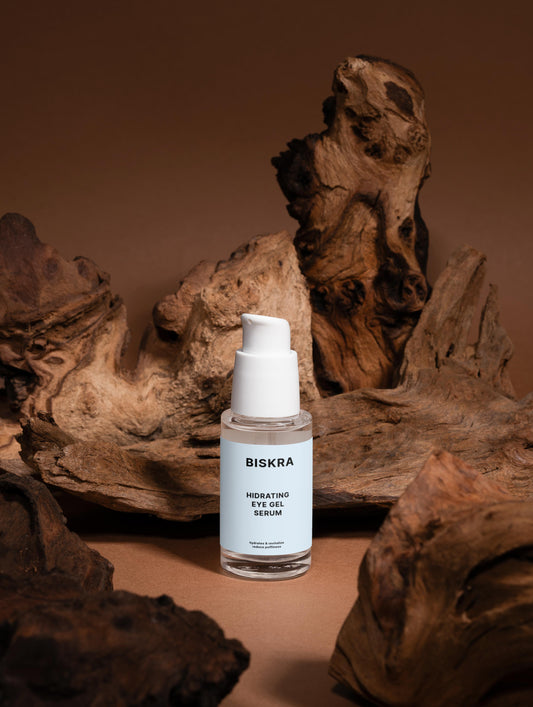 Close-up of Hydra Eye Revitalize Gel Serum in a glass bottle, showing its smooth texture and vibrant color.