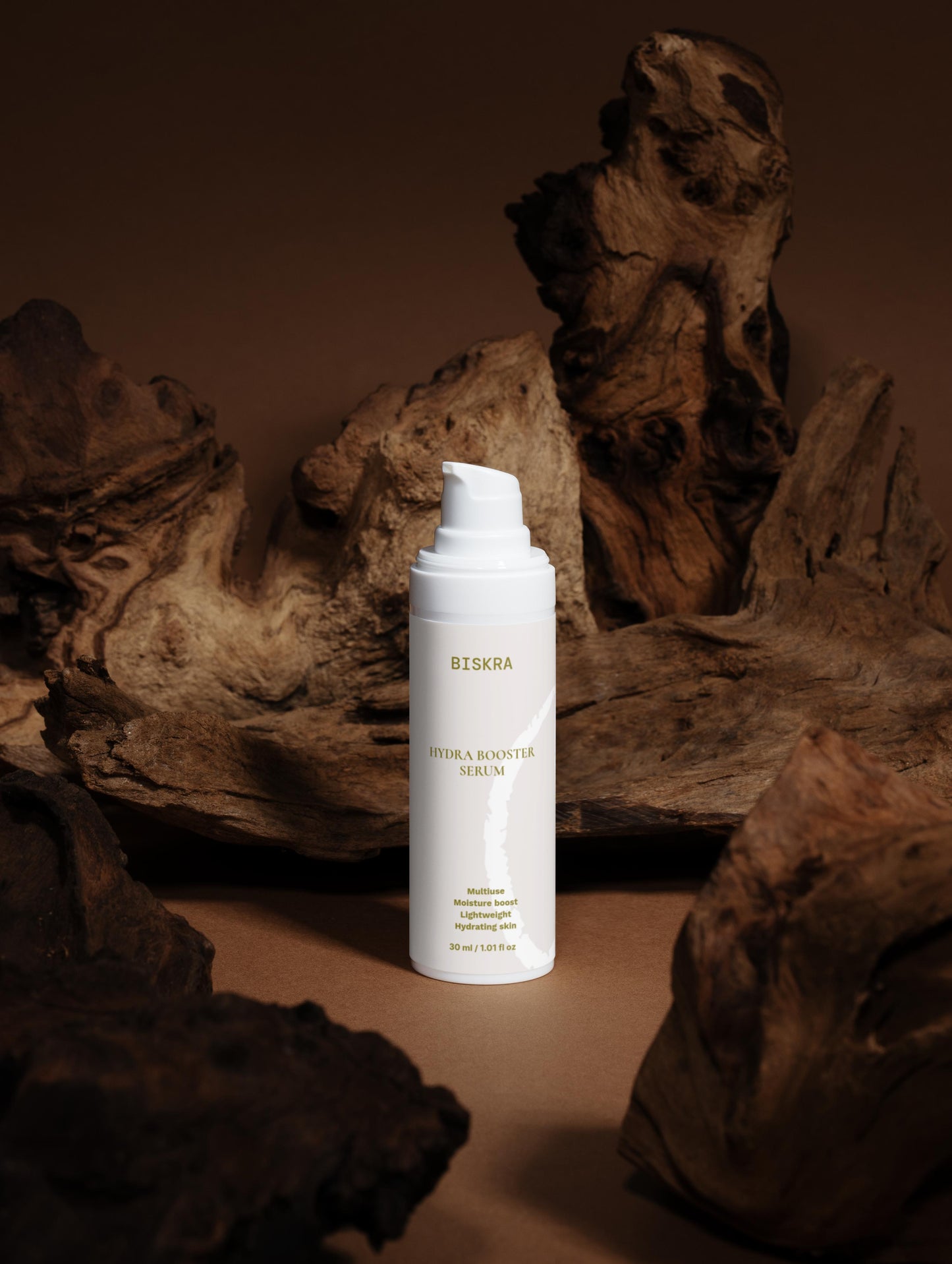 Cloudberry and peony ingredients alongside serum bottle