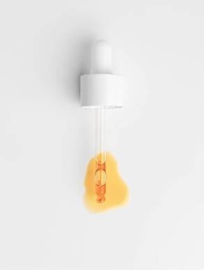 Glass dropper with golden oil – rich in antioxidants and vitamins