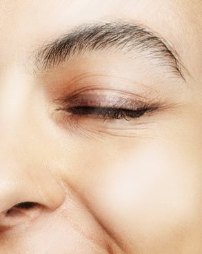 Model applying Hydra Eye Revitalize Gel Serum under the eyes to reduce puffiness and dark circles.