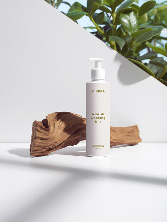 Nourishing Cleansing Milk product bottle on neutral background