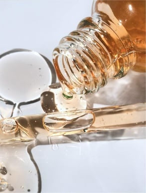 Transparent serum texture shown on back of hand in daylight