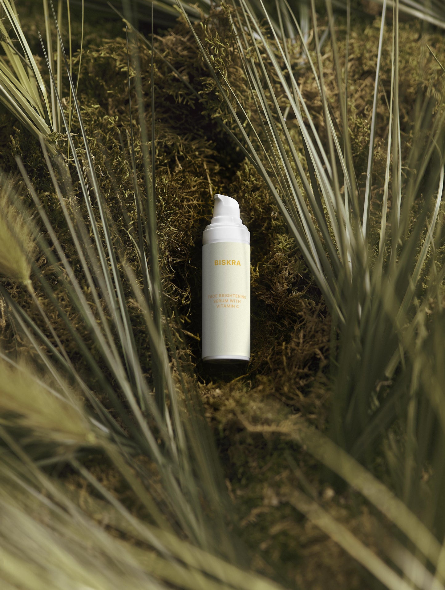 "Dropper dispensing Vitamin C serum onto the back of a hand."