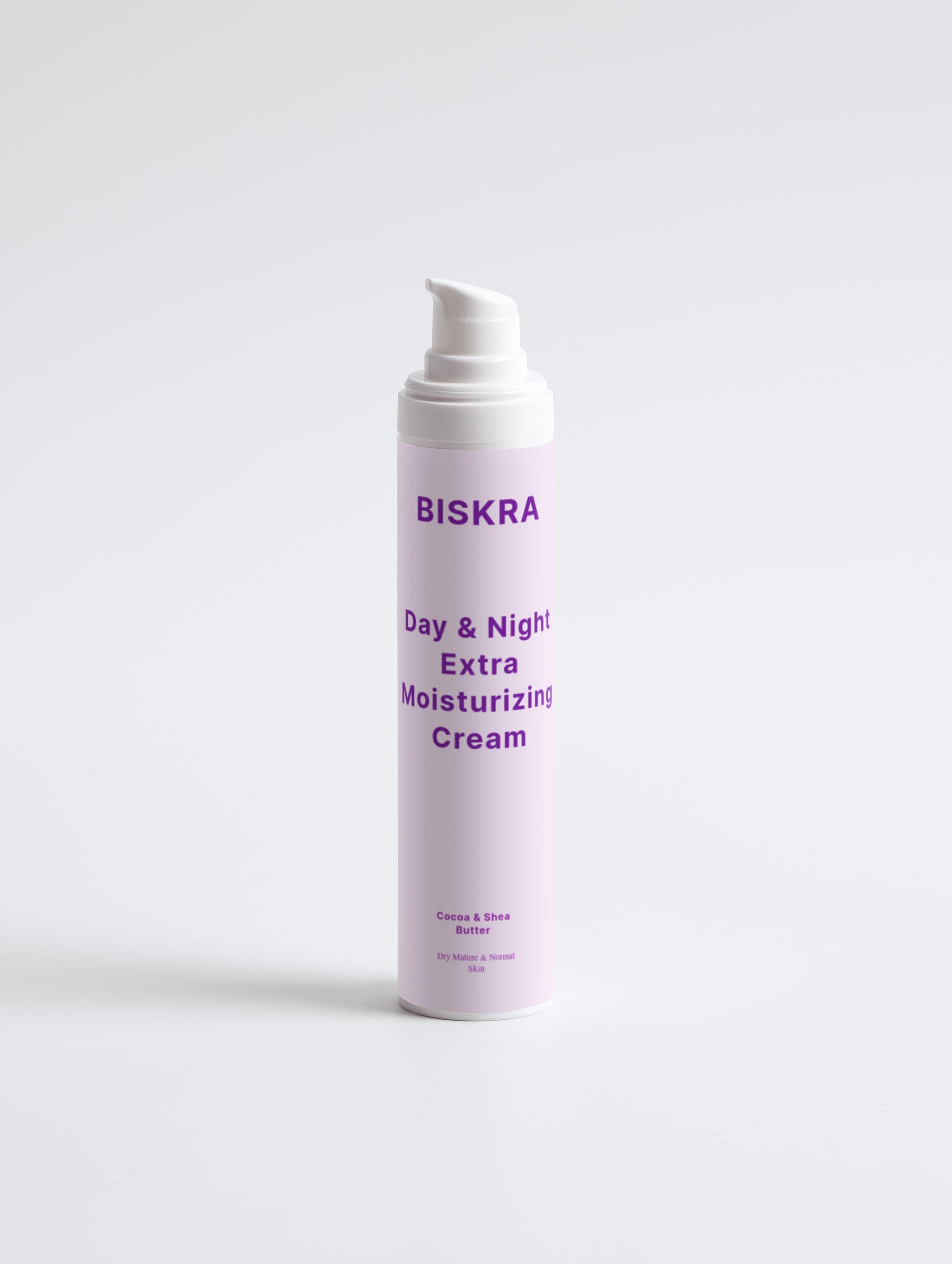 Hands holding Biskra moisturizing cream against soft lighting