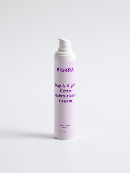 Hands holding Biskra moisturizing cream against soft lighting