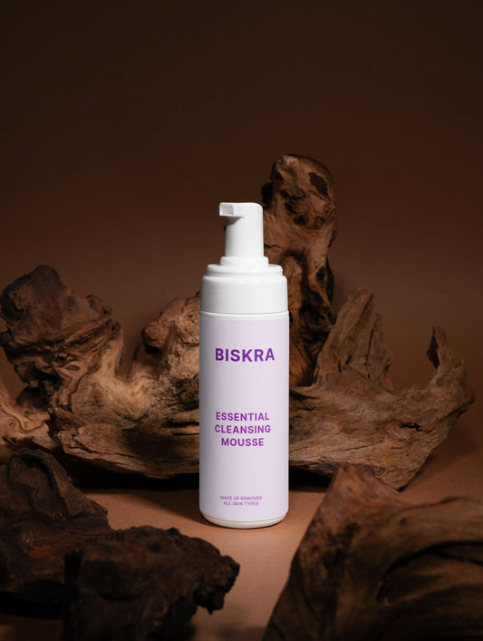 "Hydra Mousse Cleanser surrounded by rose petals, chamomile flowers, and calendula blossoms."